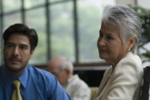Clients listening as a lawyer explains how to proceed with a medical malpractice lawsuit.