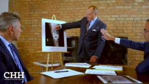 attorneys at table looking at surgical xray