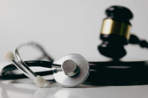 judges gavel and stethoscope on white table
