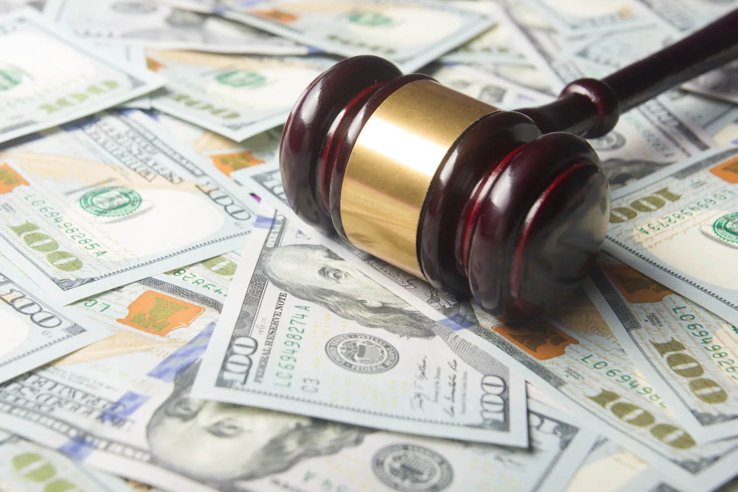 judges gavel on top of pile of money